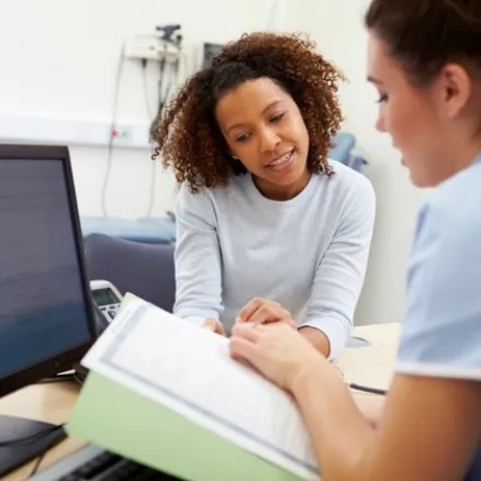 The nurse is explaining the medical record to the patient