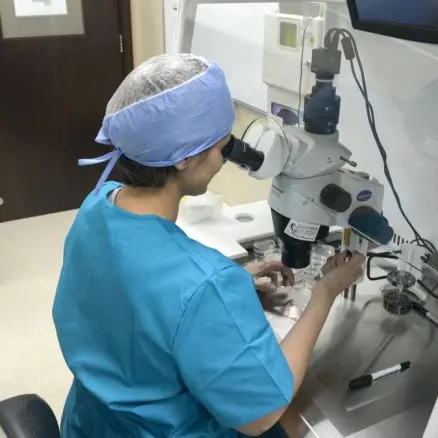 Woman looking through a microscope